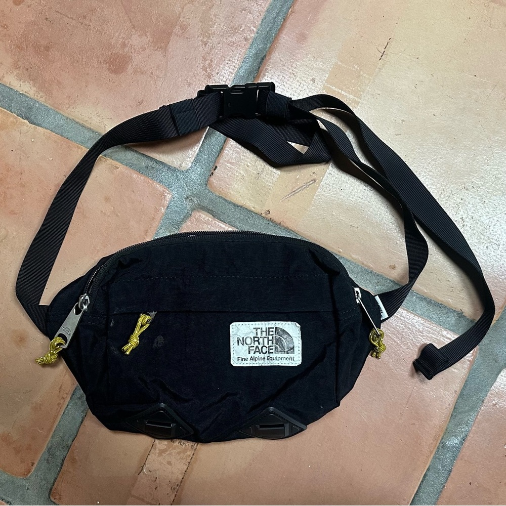The North Face Black Belt Bag with Yellow Accents with small stains